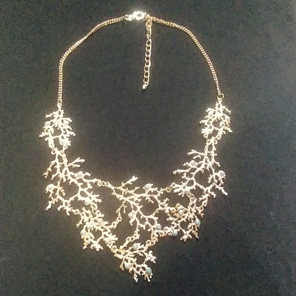 Gold necklace with blue detail.
